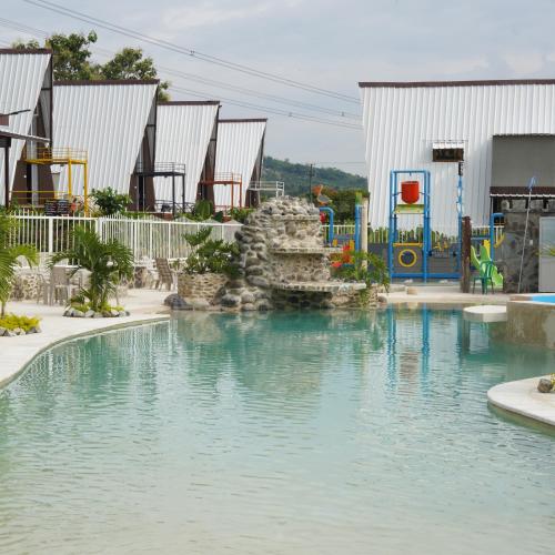a swimming pool with a water slide in a playground at Corralito de Piedra - Chalet in Rizaralda