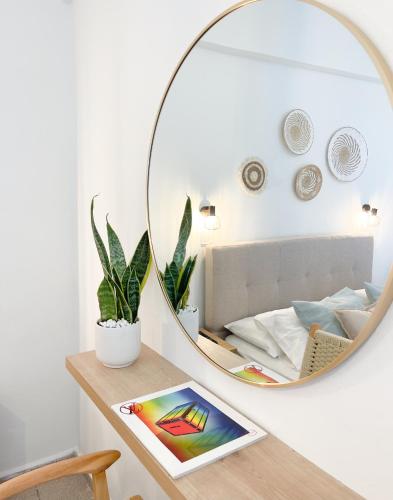 a mirror on a table in a room with a bed at Venetia in Tsoútsouros