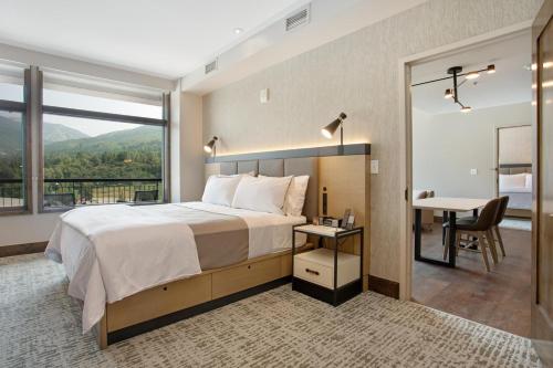 a bedroom with a bed and a desk and a window at Westin Resort 721 in Avon