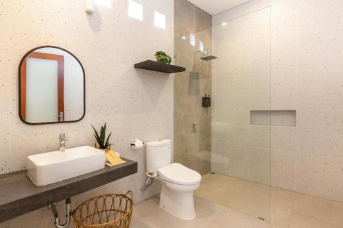 a bathroom with a toilet and a sink and a mirror at Villa Lavinia - Private Pool Villa - Seminyak Kuta - Double Six Beach in Seminyak