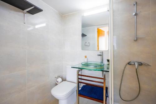 a bathroom with a toilet and a glass sink at Villa Athena in Kato Yialia