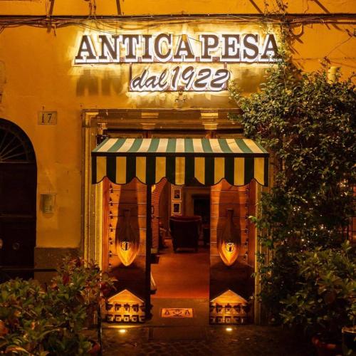 an entrance to an antigua dance restaurant at night at CASA PANIERI in Rome