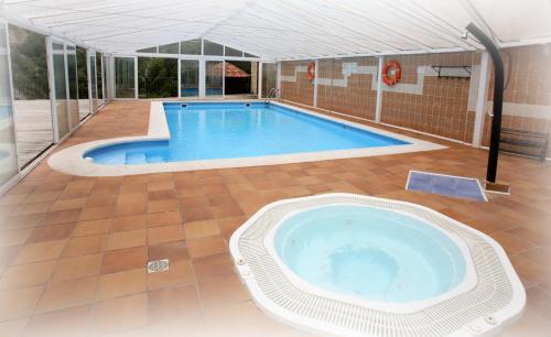 a large swimming pool in a house at Hotel Puente Vidosa in Amieva