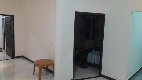 a chair and a mirror in a room at Theepan's Home in Nilaveli