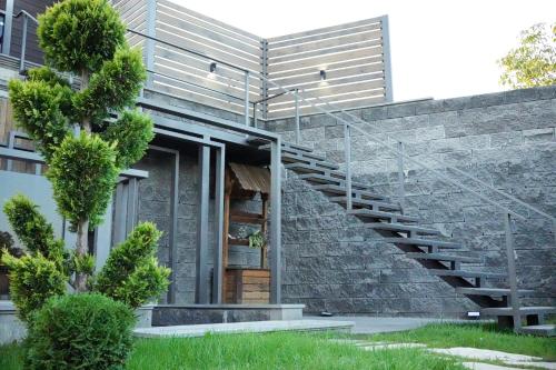 a brick building with a staircase in front of it at Garden Hills in Garni