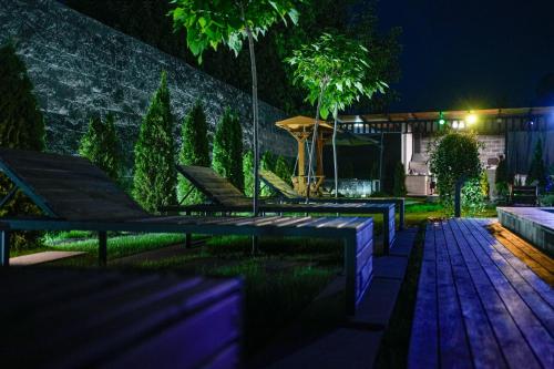a backyard at night with a table and benches at Garden Hills in Garni