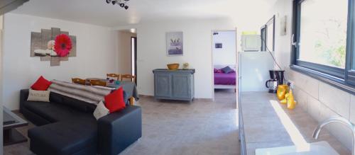 a living room with a couch and a refrigerator at Le Clos Saint Elme in Collioure