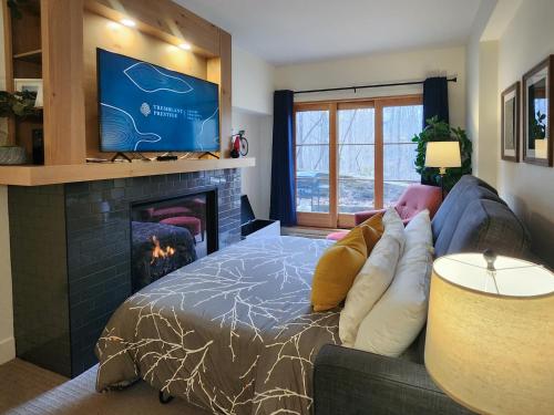 a living room with a bed and a fireplace at Tremblant Prestige - Étoile 1500-2 in Mont-Tremblant