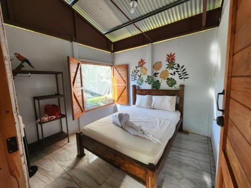 a bedroom with a bed in a room with a window at Boca Tapada Inn in Boca Tapada
