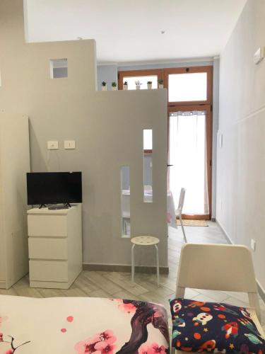 a living room with a bed and a tv at Sicily Sud-Est in Avola