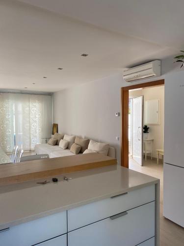 a white kitchen with a bed in a room at House 50meters from the beach in Cunit
