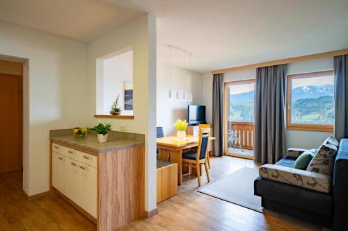 a kitchen and living room with a couch and a table at Frühstückspension Götzfried-Hof in Millstatt