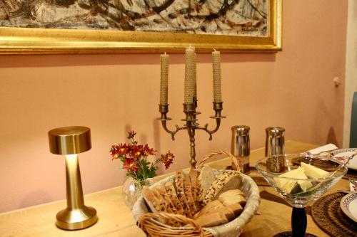 a dining room table with a candle and acandle at Pensiunea Agora in Cisnadioara