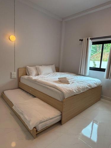 a bedroom with a large bed with a pull out mattress at Cloud Nine House Betong in Betong