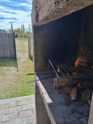 a brick oven with a fire inside of it at Ciruelos del Sur - San Rafael Mendoza in San Rafael