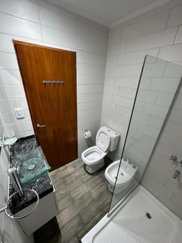 a bathroom with a toilet and a shower and a sink at Los Olivos in Federación