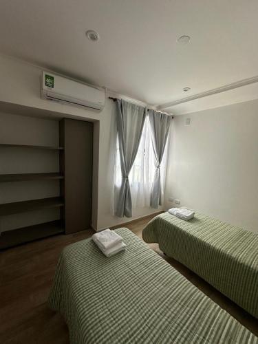 a room with two beds and a window in it at Los Olivos in Federación