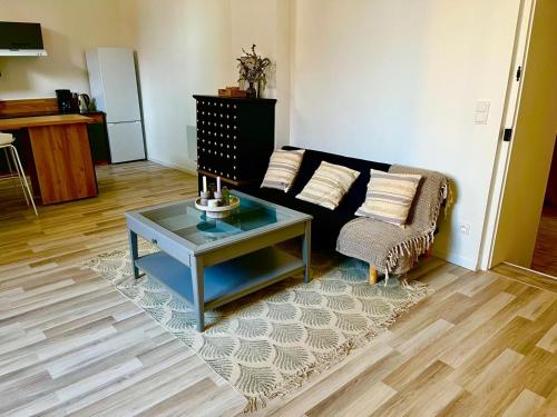 a living room with a couch and a table at Assarag in Brienon-sur-Armançon