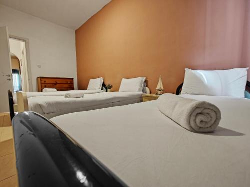 a bedroom with two beds with towels on them at Sliema 3 bedrooms apartment in Sliema