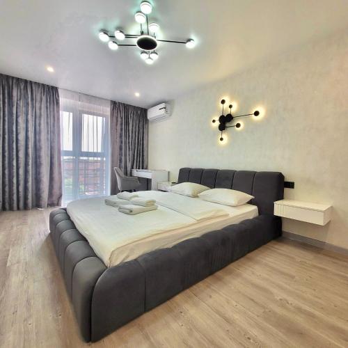 una camera da letto con un grande letto con una struttura nera di ApartPoltava Graphite Luxe Ремонт 2025 Престижна новобудова в ЦЕНТРІ міста a Poltava