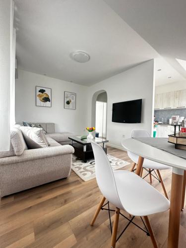 a living room with a couch and a table at Airport Apartments MM in Golubovci