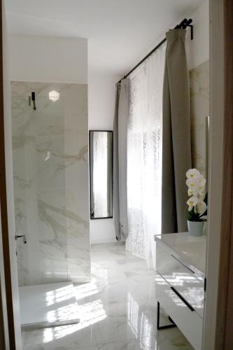 a bathroom with a glass shower and a sink at La Rocca sui Trabocchi in Rocca San Giovanni