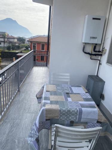 a balcony with two tables and chairs on a balcony at Lago Maggiore in Intra