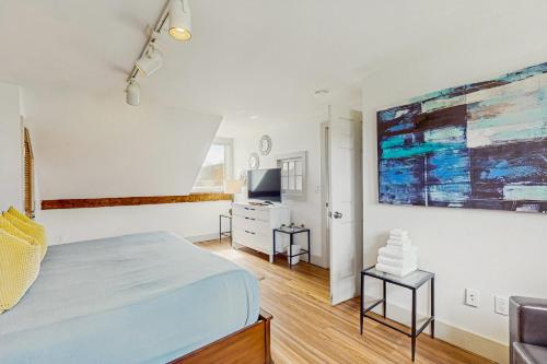 a bedroom with a bed and a desk and a tv at Stowe Mountain Road Getaway in Stowe