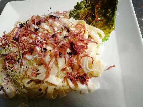 a plate of food with pasta and vegetables at Hotel Banatium B&B Cucina in Tezze sul Brenta
