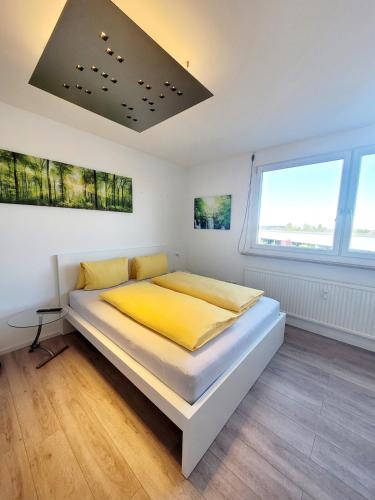 a bedroom with a large bed with yellow sheets at Mini Sun in Dornbirn