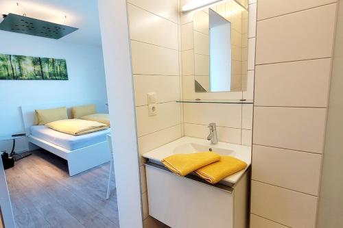a bathroom with a sink and a mirror at Mini Sun in Dornbirn