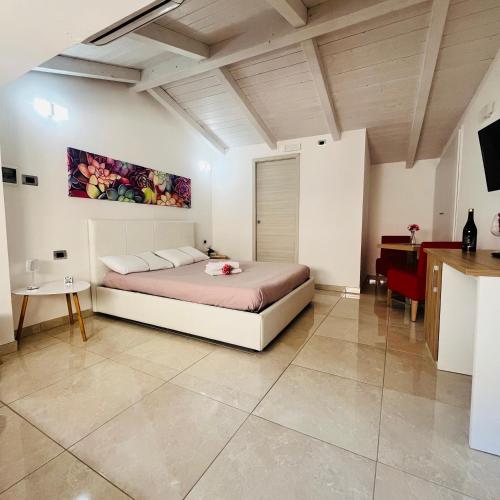 a large bedroom with a bed and a table at La Meridiana - centro storico di Pizzo in Pizzo