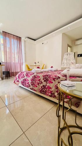 a bedroom with a large bed and a table at La Meridiana - centro storico di Pizzo in Pizzo