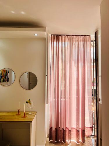 a room with a window with a pink curtain at La Meridiana - centro storico di Pizzo in Pizzo