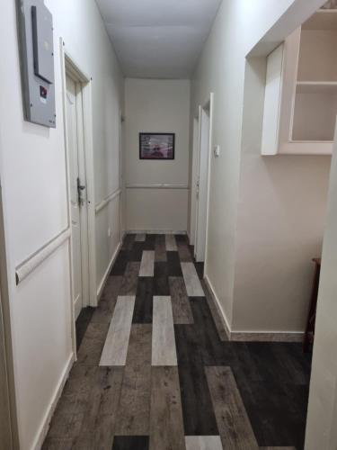 a hallway with a checkered floor and white walls at 2 bedroom house in Tema in Tema