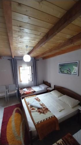 a bedroom with two beds in a room with a ceiling at Te Agostini in Theth