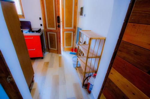 a room with a kitchen with a wooden floor at Old Style by the sea, roof terrace with pool and kitchen, Ladispoli in Ladispoli