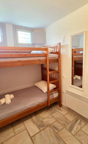 two bunk beds in a room with a mirror at Serifos Rock Villa in Serifos Chora
