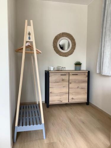a wooden ladder next to a dresser in a room at Tulipán Ház Gyál in Gyál