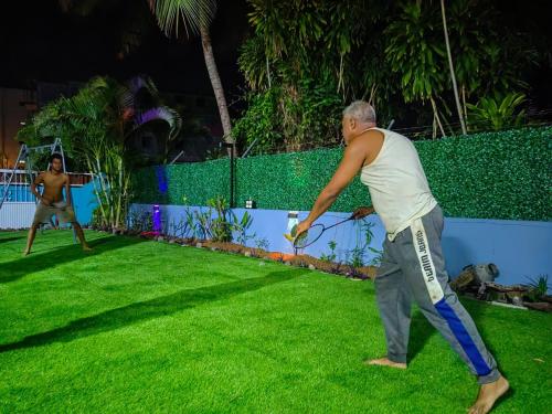 a man playing with a frisbee in the grass at Lariad BNB in Rivière Noire