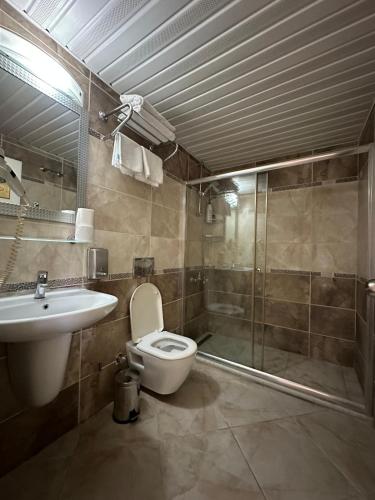 a bathroom with a toilet and a shower and a sink at Barby Butik Otel in Kemer
