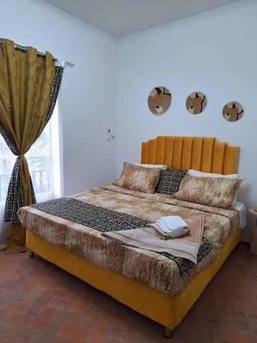 a large bed in a room with a window at Central Apartment with view, 2 bedrooms, living room, kitchen, 1 bathroom in Saint-Louis