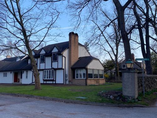 a white house with a chimney on a street at Serenity on the Lake in Niagara on the Lake