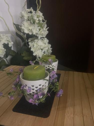 a couple of cakes sitting on a table with flowers at Casa Vacanza Betty in Partanna