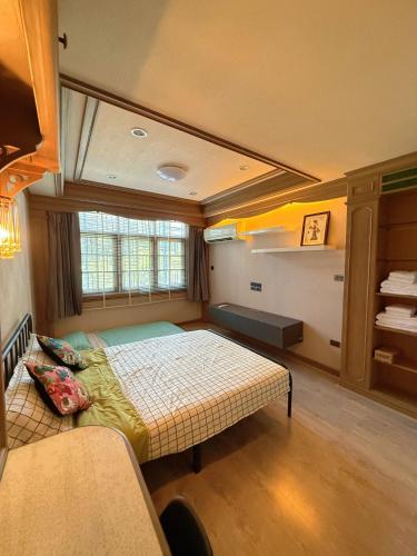 a bedroom with a bed and a window at Regalohome Br in Bangkok