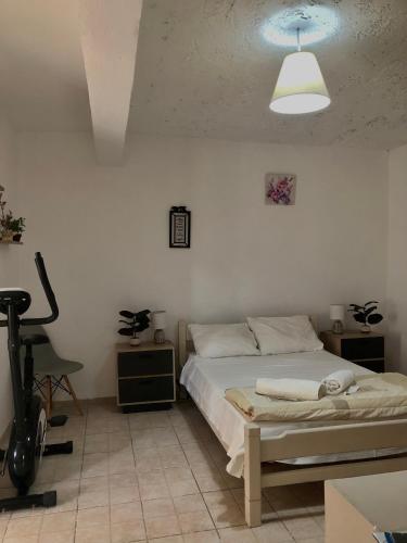 a bedroom with a bed and a desk and a lamp at Argyro's vintage House in Spílion