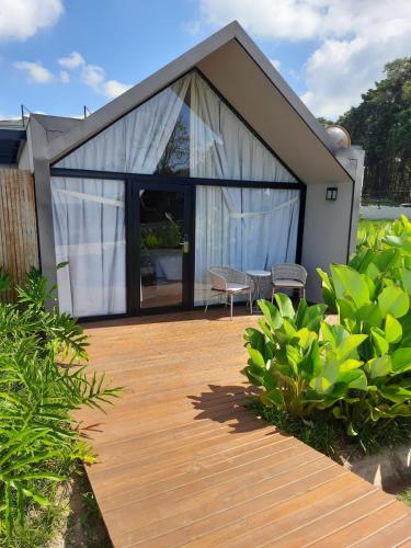 a house with a wooden deck in front of it at NÖR Hotel & SPA in São Roque