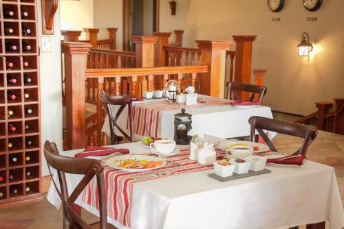 a table with a white table cloth with food on it at Leopardsong Manor in Centurion