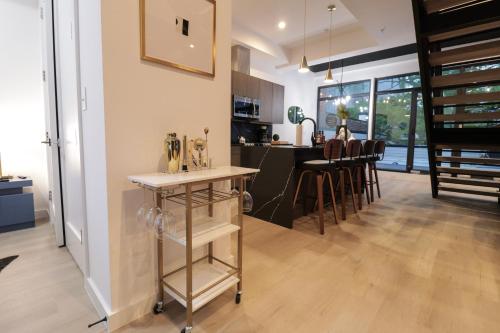 a kitchen and living room with a table and chairs at Unit 8 Spacious 2BR Penthouse Sleeps 8 in Washington, D.C.