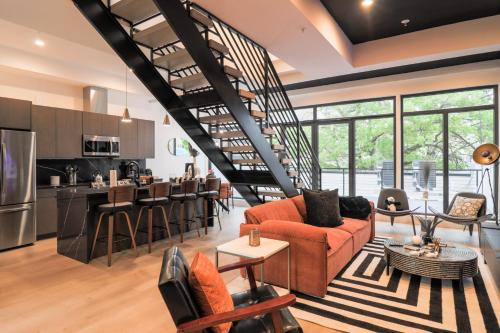 a living room and kitchen with a spiral staircase at Unit 8 Spacious 2BR Penthouse Sleeps 8 in Washington, D.C.